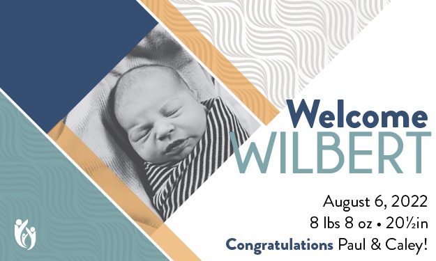 Black and white photo of a sleeping baby in striped clothing. Text: “Welcome Wilbert. August 6, 2022. 8 lbs 8 oz · 20½ in. Congratulations Paul & Caley!” Geometric blue, tan, and white background design celebrating Wilbert’s arrival.